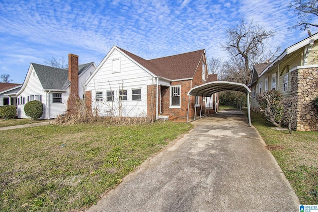 view of front of property featuring a garage, a front lawn, and a carport