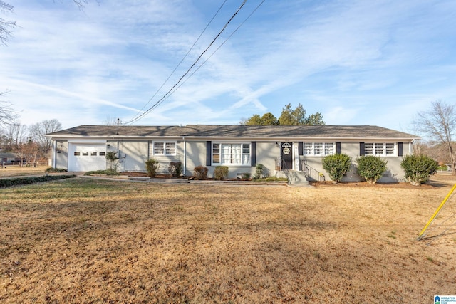 ranch-style home with a garage and a front lawn