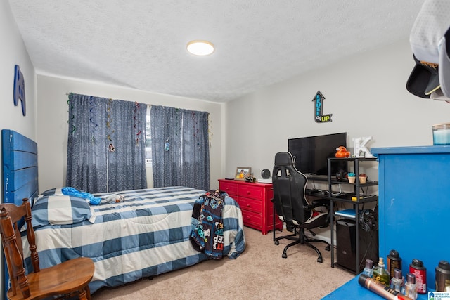 bedroom with a textured ceiling and light colored carpet