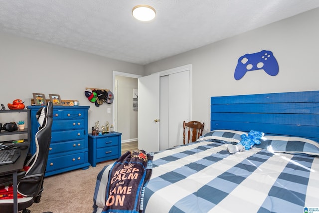 carpeted bedroom with a textured ceiling and a closet