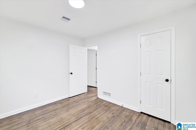 unfurnished bedroom featuring hardwood / wood-style flooring