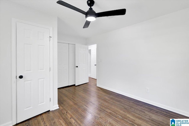 unfurnished bedroom with a closet, ceiling fan, and dark hardwood / wood-style flooring