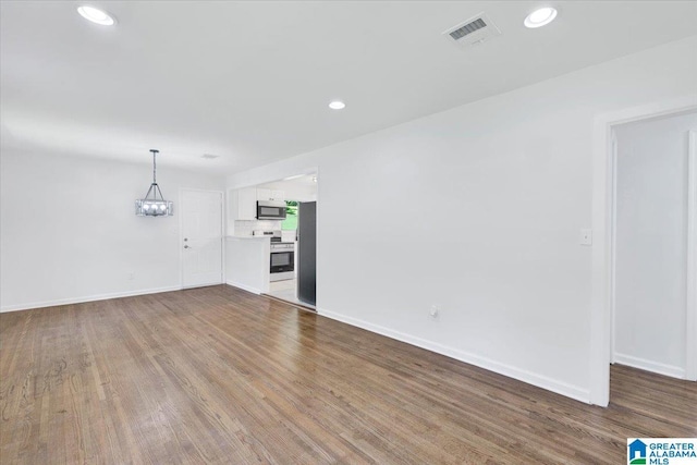 unfurnished living room with wood-type flooring