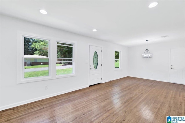 entryway with hardwood / wood-style flooring and an inviting chandelier