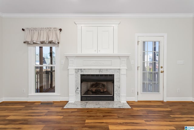 unfurnished living room with dark hardwood / wood-style flooring, a fireplace, and ornamental molding