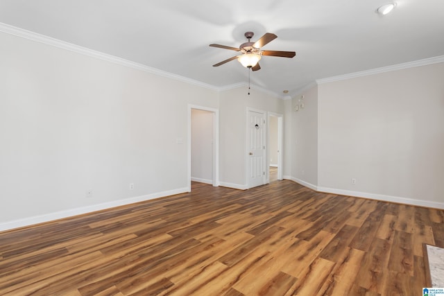 empty room with ceiling fan, hardwood / wood-style floors, and crown molding