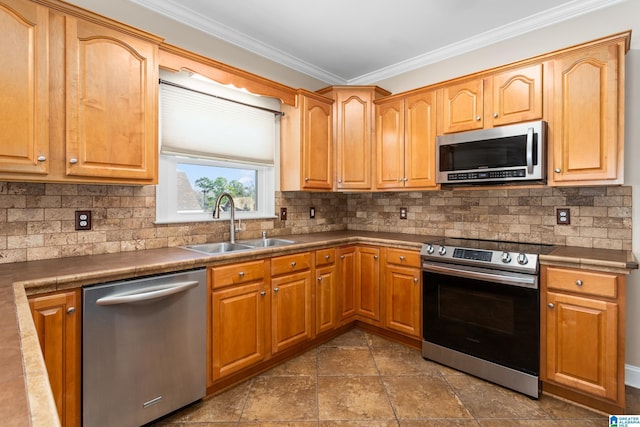 kitchen featuring sink, crown molding, stainless steel appliances, and tasteful backsplash