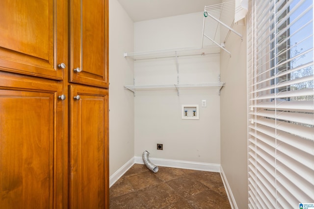 washroom with cabinets, hookup for a washing machine, and electric dryer hookup