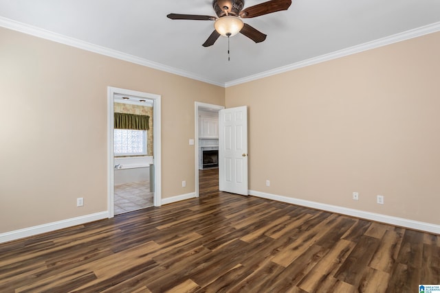 unfurnished bedroom with ceiling fan, ensuite bath, dark hardwood / wood-style flooring, and crown molding