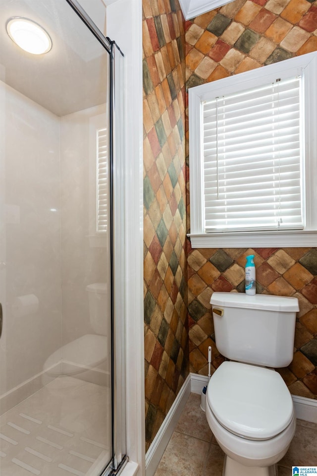 bathroom with toilet and tile patterned flooring