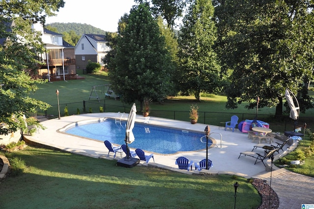 view of pool with a yard