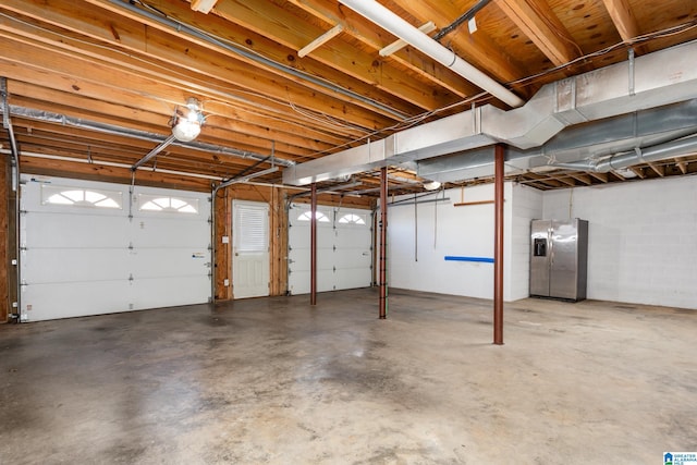 garage with stainless steel fridge with ice dispenser