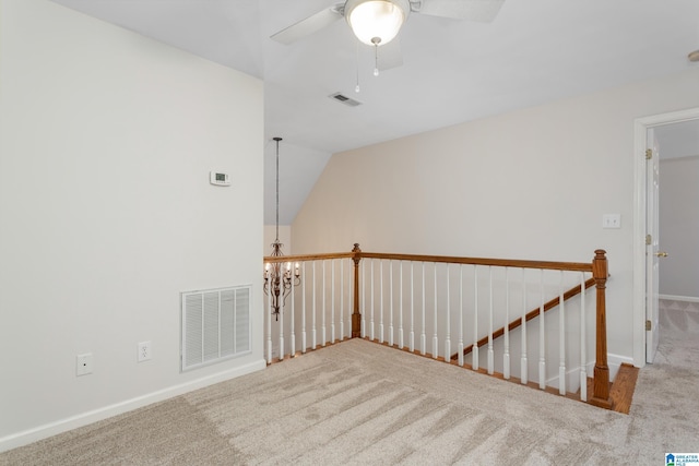 carpeted empty room with ceiling fan and lofted ceiling