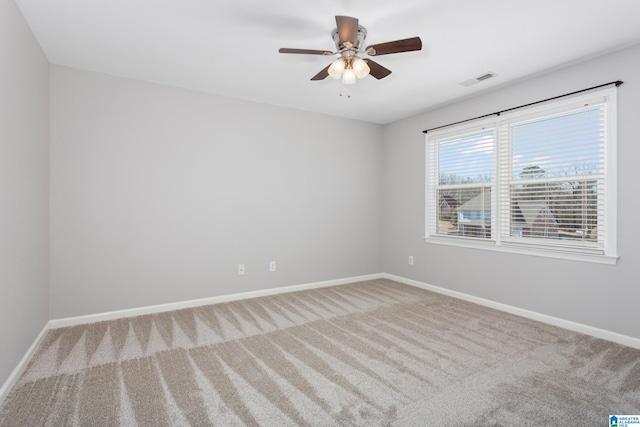 spare room featuring ceiling fan and light colored carpet