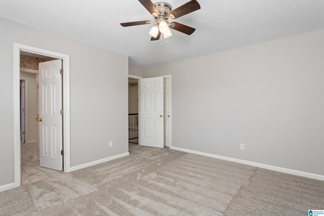 unfurnished bedroom featuring light carpet and ceiling fan