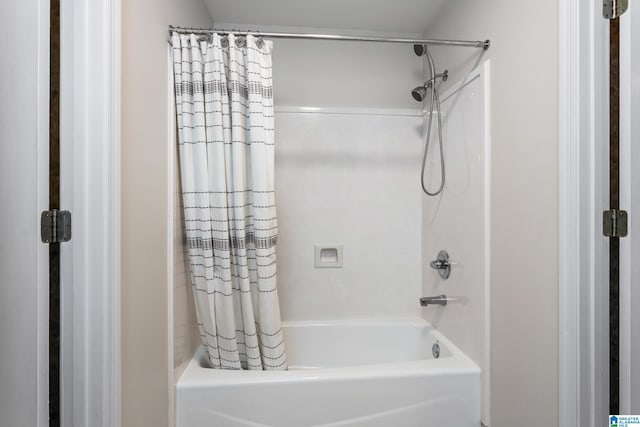 bathroom with shower / bath combination with curtain