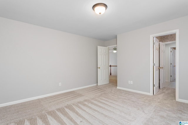 unfurnished bedroom featuring light carpet