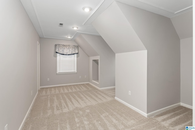 bonus room with light carpet and lofted ceiling