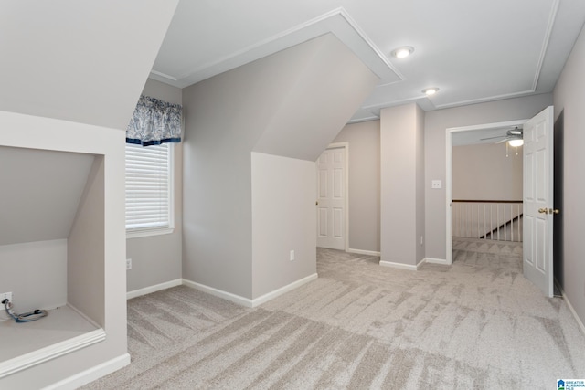 bonus room with ceiling fan, light carpet, and vaulted ceiling