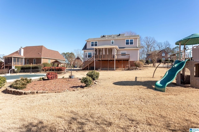 back of house featuring a sunroom and a playground