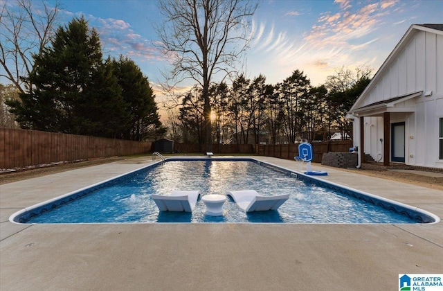 pool at dusk with a patio