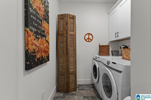 clothes washing area with washer and dryer and cabinets