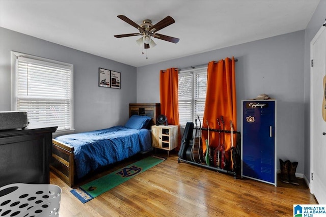 bedroom with hardwood / wood-style flooring and ceiling fan