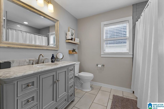 bathroom featuring toilet, tile patterned floors, and vanity