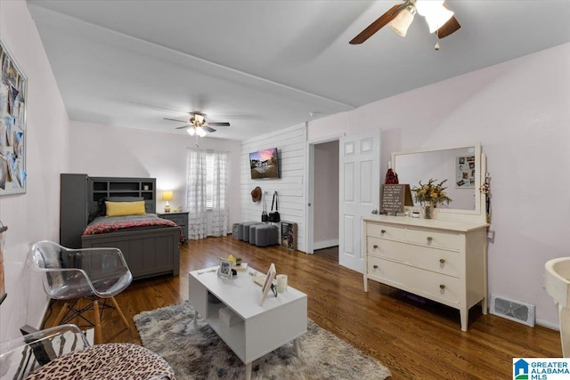 living room with ceiling fan and dark hardwood / wood-style floors