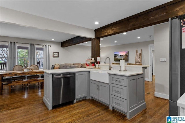 kitchen featuring dishwasher, gray cabinetry, dark hardwood / wood-style flooring, beam ceiling, and sink