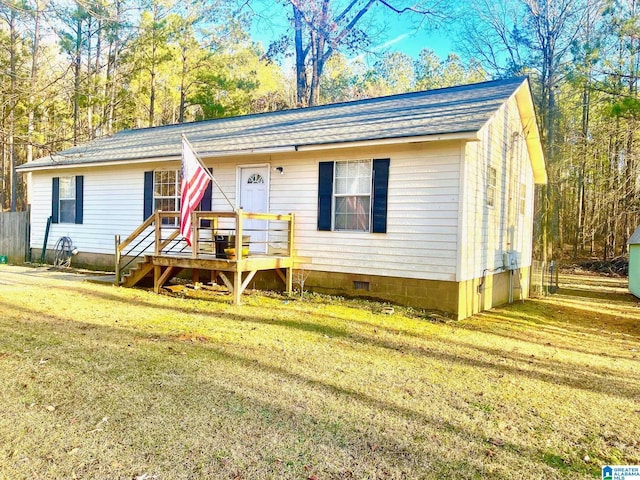 ranch-style house with a wooden deck and a front lawn