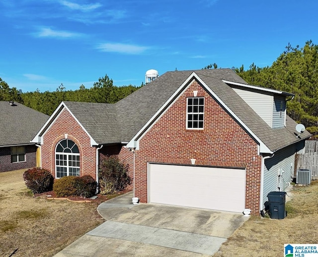 view of front property with a front yard, a garage, and central air condition unit