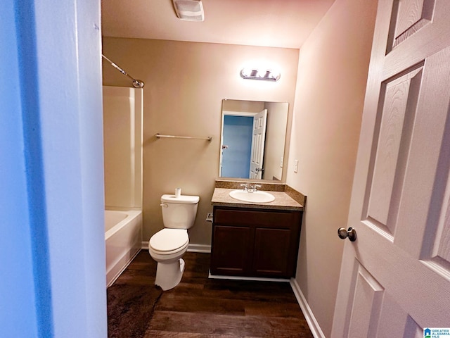 full bathroom featuring hardwood / wood-style floors, toilet, vanity, and bathing tub / shower combination