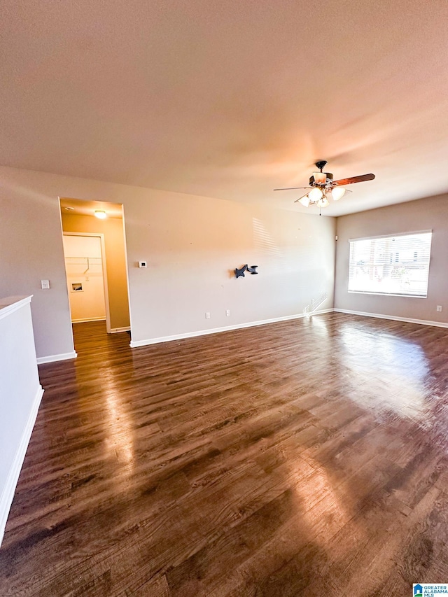 empty room with ceiling fan and dark hardwood / wood-style floors