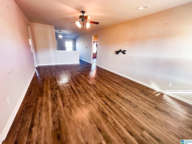 unfurnished room with ceiling fan and dark hardwood / wood-style floors