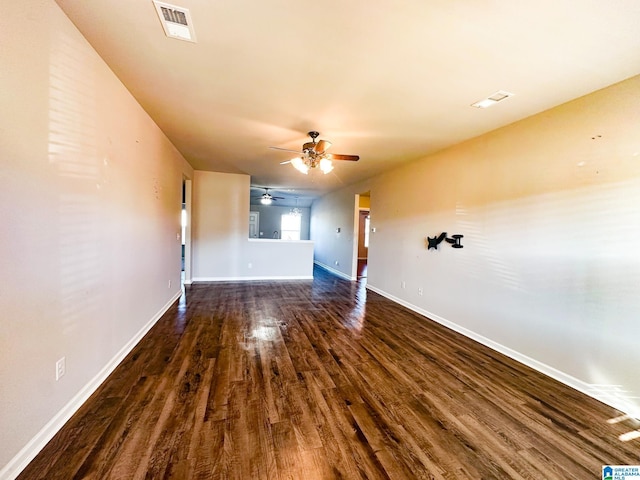 unfurnished living room with dark wood-type flooring and ceiling fan