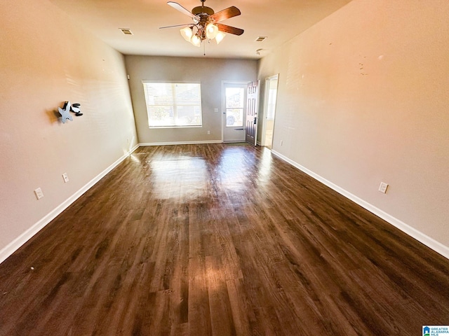 spare room with ceiling fan and dark hardwood / wood-style flooring