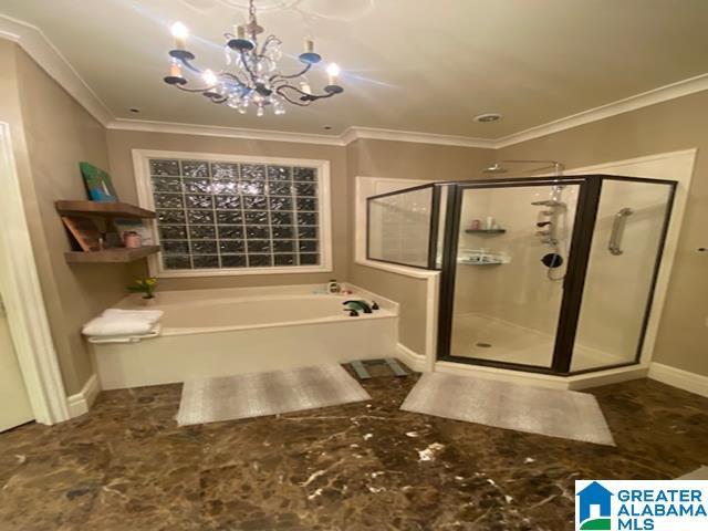 bathroom with crown molding, an inviting chandelier, and shower with separate bathtub