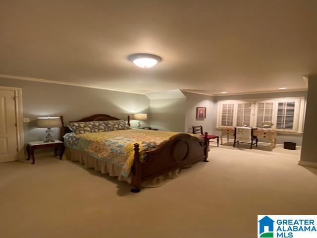 carpeted bedroom featuring ornamental molding