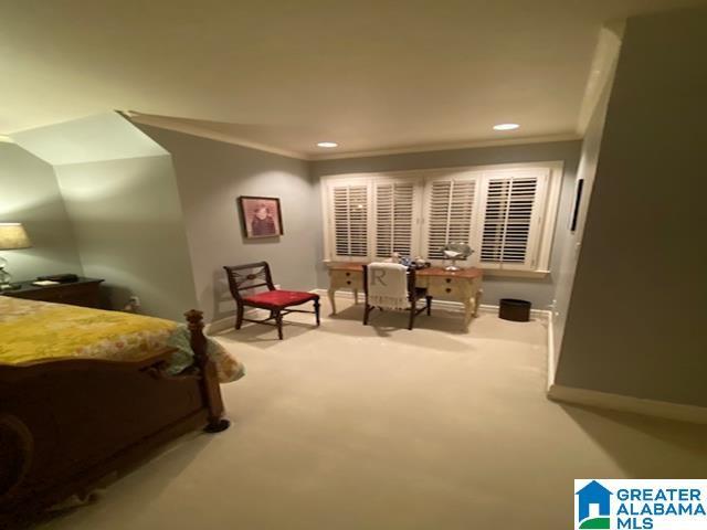 carpeted bedroom featuring crown molding