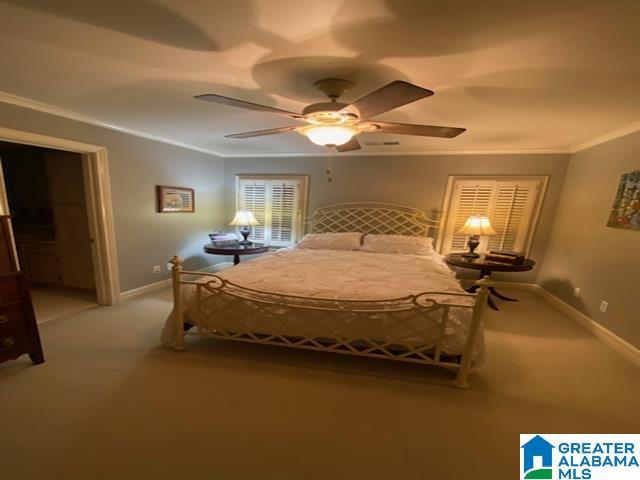 unfurnished bedroom with carpet, ceiling fan, and ornamental molding