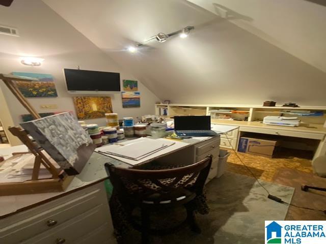 home office with lofted ceiling