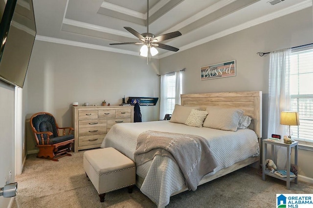 bedroom featuring a tray ceiling, ornamental molding, light colored carpet, and ceiling fan