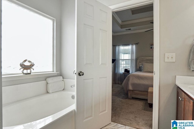 bathroom with a washtub, vanity, and ornamental molding