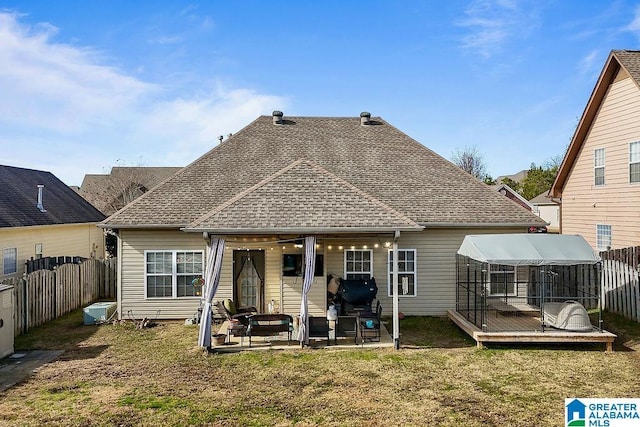 back of house with a wooden deck, a yard, and a patio area