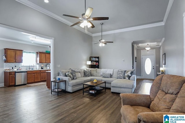 living room featuring dark hardwood / wood-style flooring, sink, ornamental molding, and ceiling fan