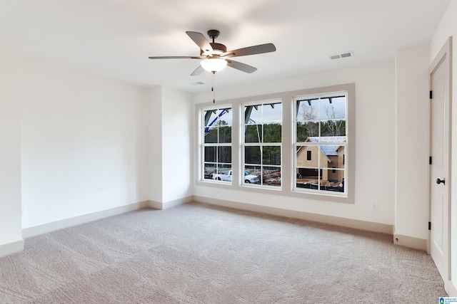 unfurnished room with ceiling fan and light colored carpet