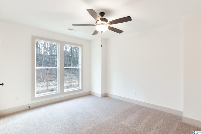 carpeted empty room featuring ceiling fan