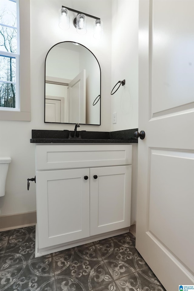 bathroom with toilet and vanity