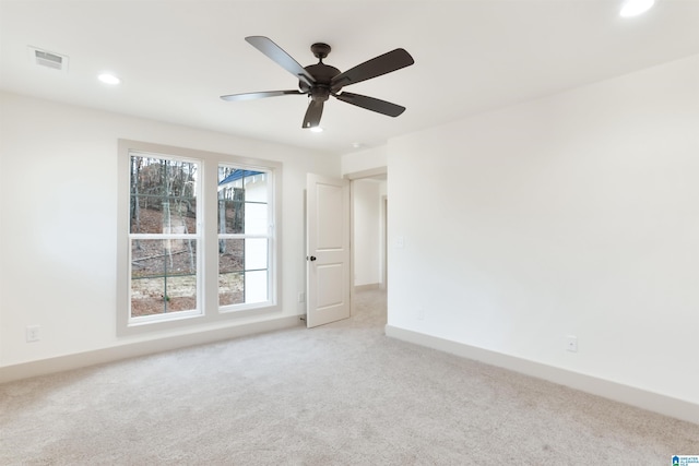 carpeted spare room featuring ceiling fan